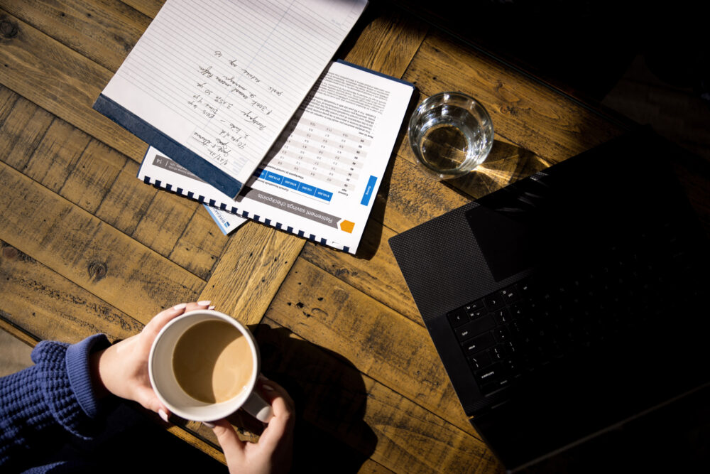 papers and laptop on desk